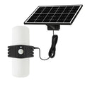Black outdoor solar security floodlight with abstract design and mounting bracket on a wall.