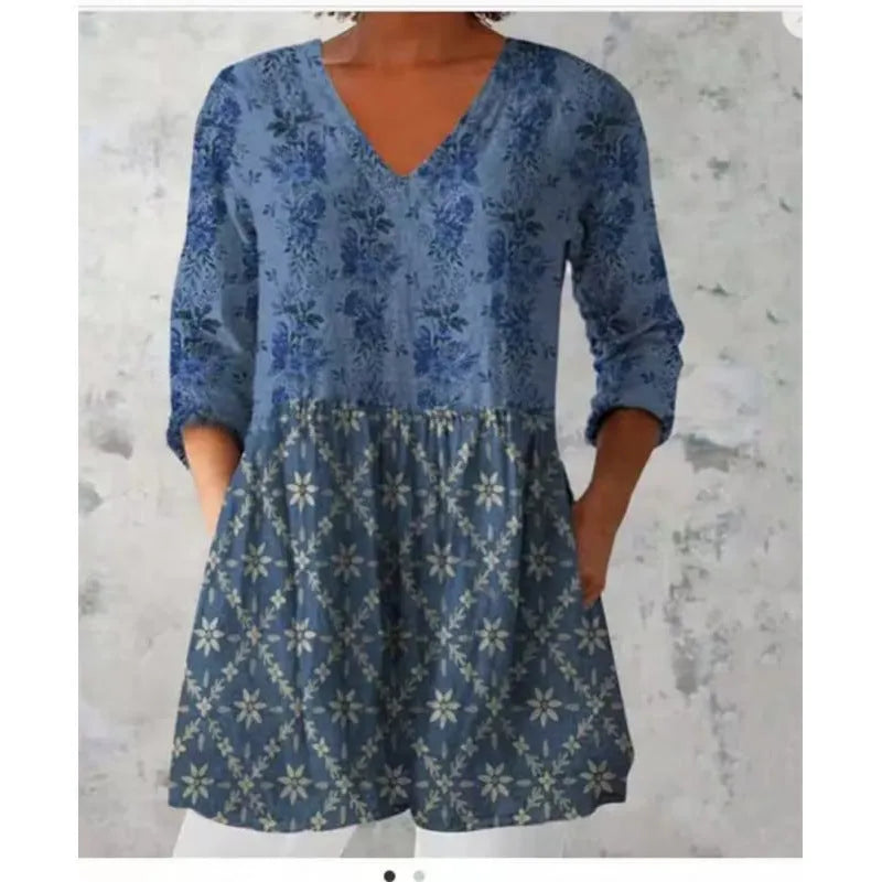 Women's loose-fit dress with blue and white wave pattern print and three-quarter length sleeves.