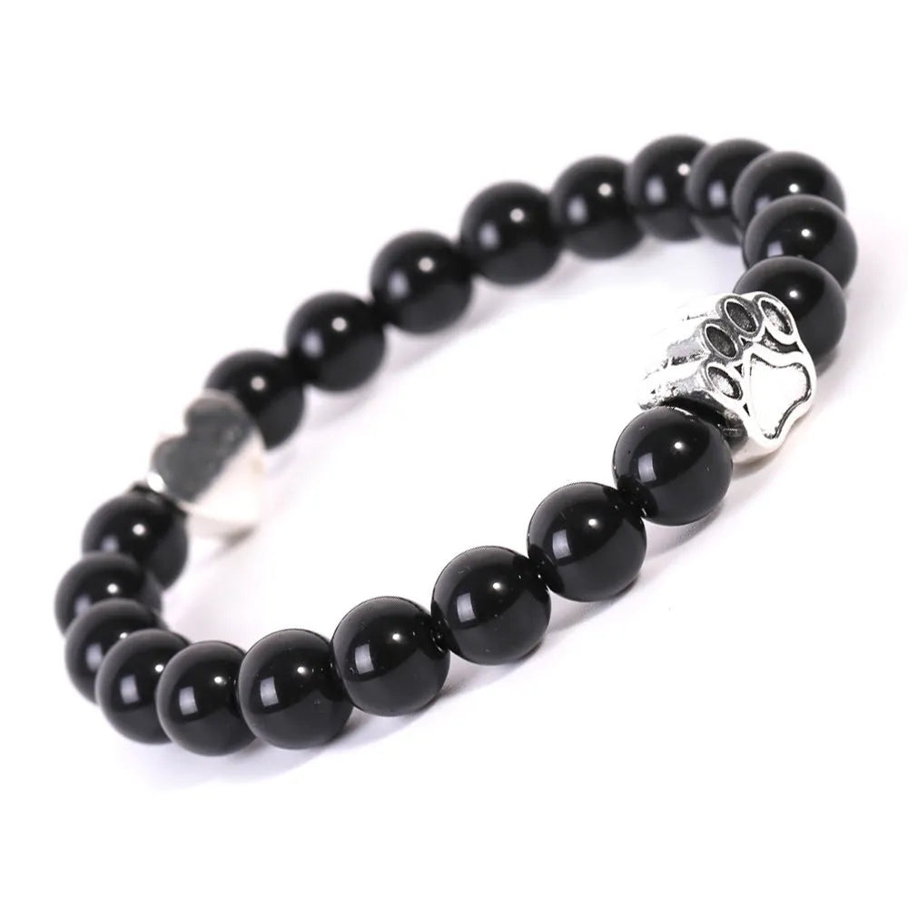 Tigereye and Indian agate stone beaded bracelet with a silver dog's paw charm and a geometric peach heart charm on a white background.