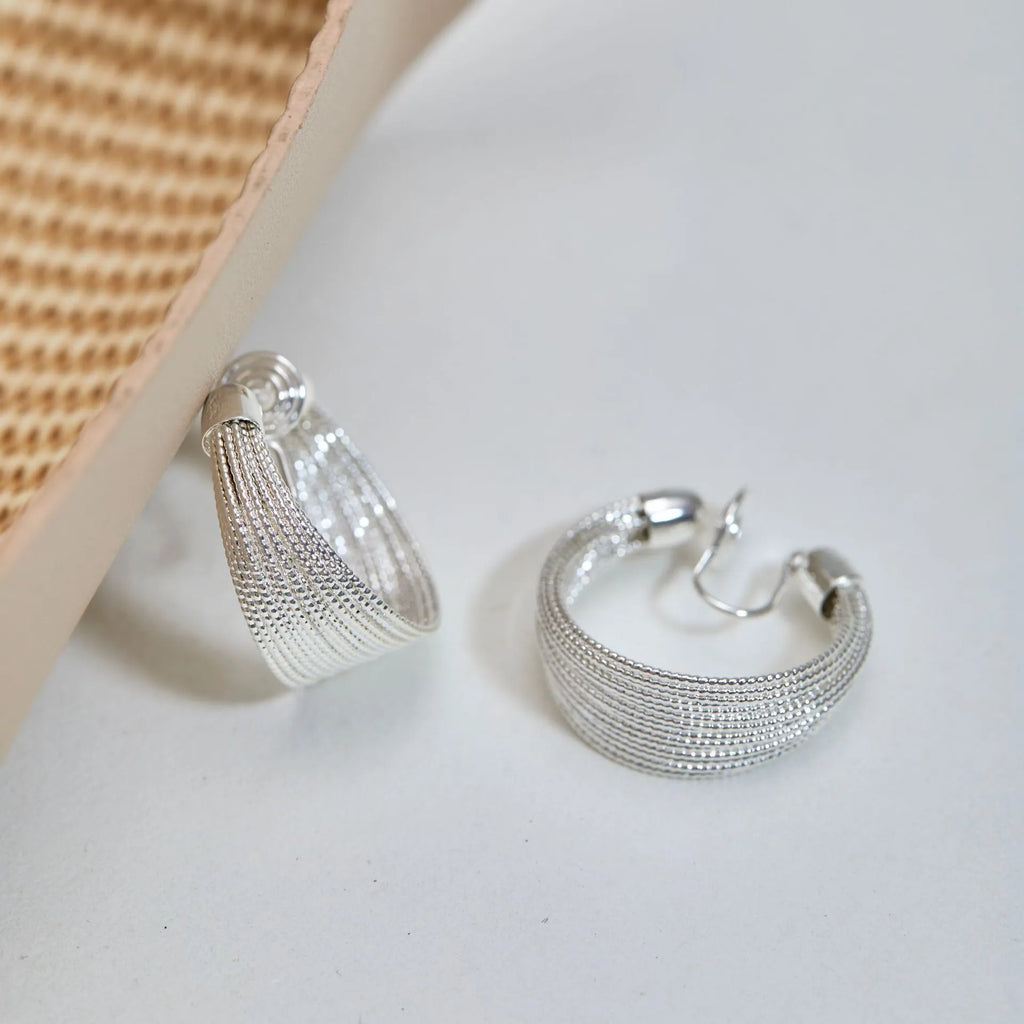 Geometric layered bracelet earrings with matching stud and clip earrings in gold or silver finishes