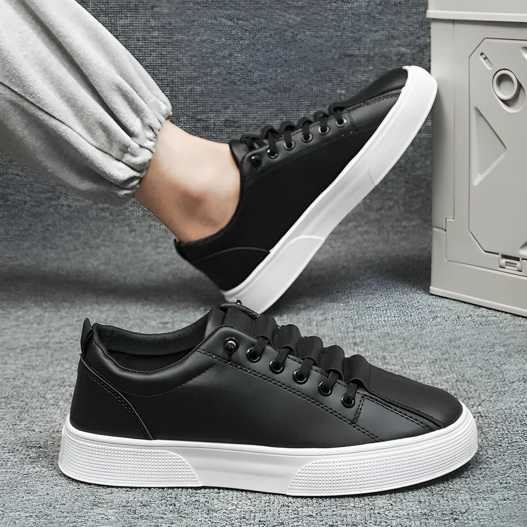 Men's black and white low top sports shoes with mesh panels and synthetic leather upper.