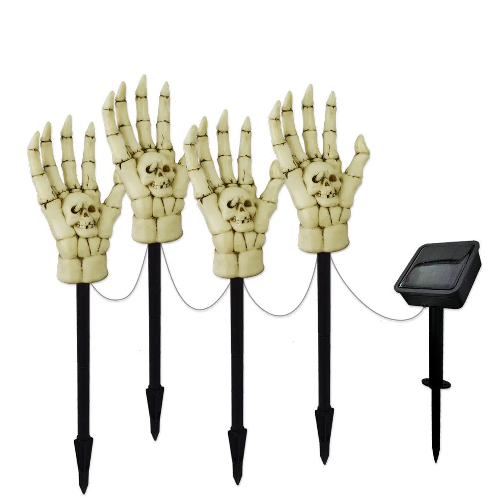 Halloween ghost hand solar light in garden setting with warm white glow, plastic IP55 waterproof construction