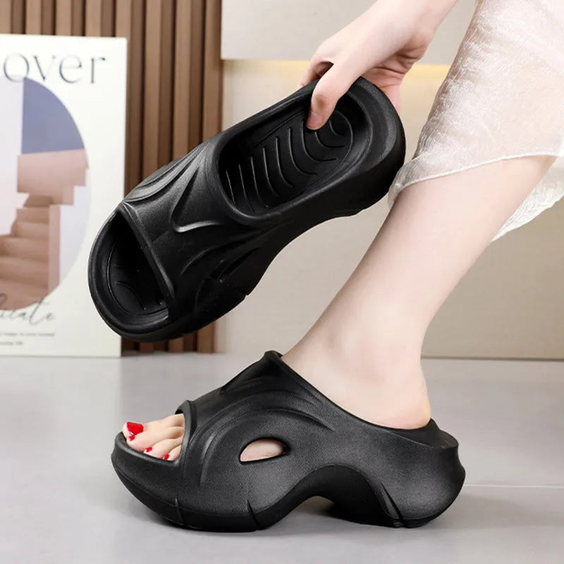 Women's white thick-soled EVA slippers with round toe on a beach background.