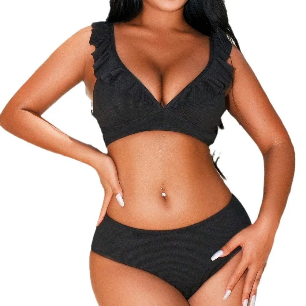 Women's black and white striped bikini with split chest design on a mannequin.