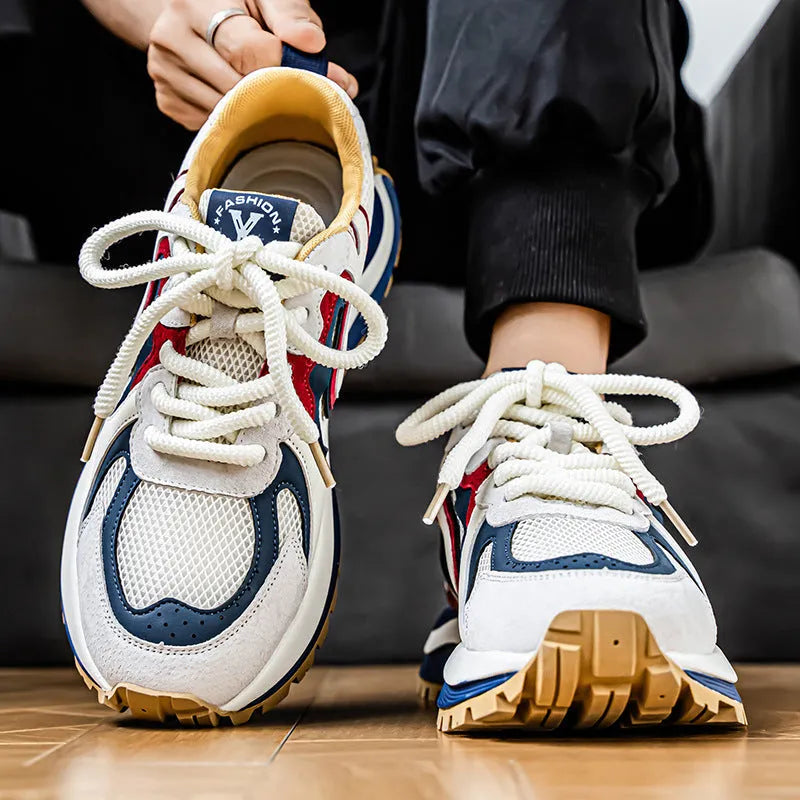 Men's yellow, black, and white mesh and synthetic leather casual sneakers with round toe and lace-up front.
