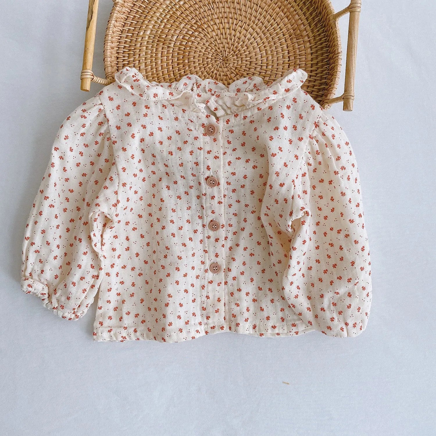 Baby girl in a pleated lotus leaf style cotton romper, triangle climb suit design for 0-2 year olds.