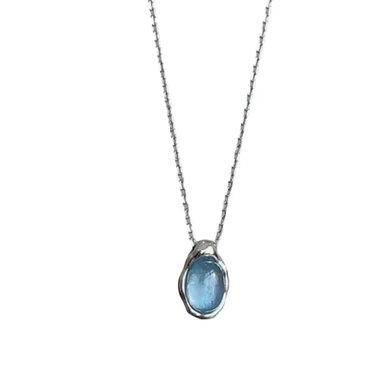 Geometric navy blue water drop pendant necklace on an adjustable copper chain.