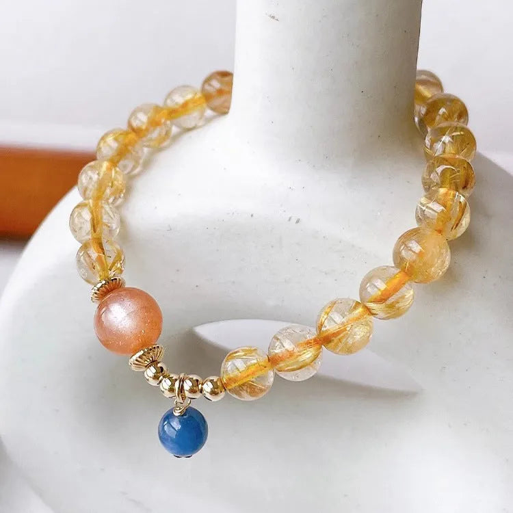 Women's gold rutilated quartz sunstone crystal bracelet with diamond-shaped and round beads