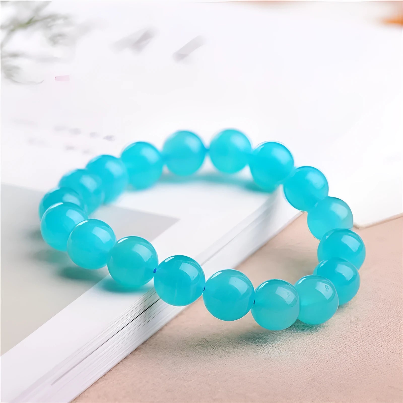 Loose polished Grade 7A Amazonite beads in various sizes on a white background.