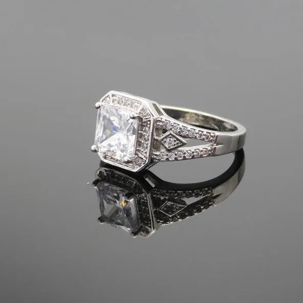Geometric hollow design women's zircon ring in platinum finish on copper, showing quadrilateral stone.