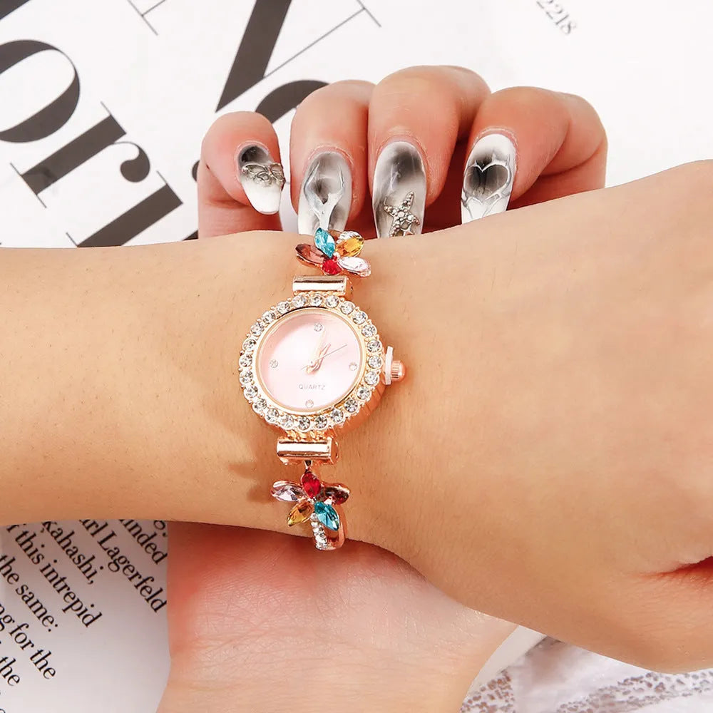 Round women's quartz watch on alloy bracelet with diamond accents and gold finish