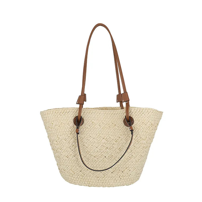 A retro-style horizontal square woven bag in milky white, shown being carried by hand.