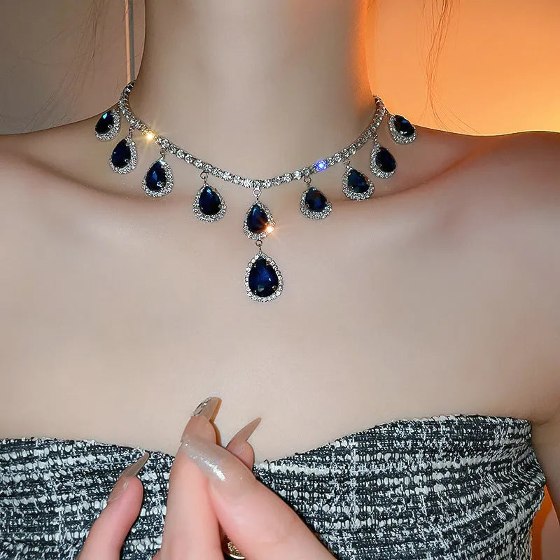 Silver needle water drop earrings and necklace set with blue zircon pendant on display
