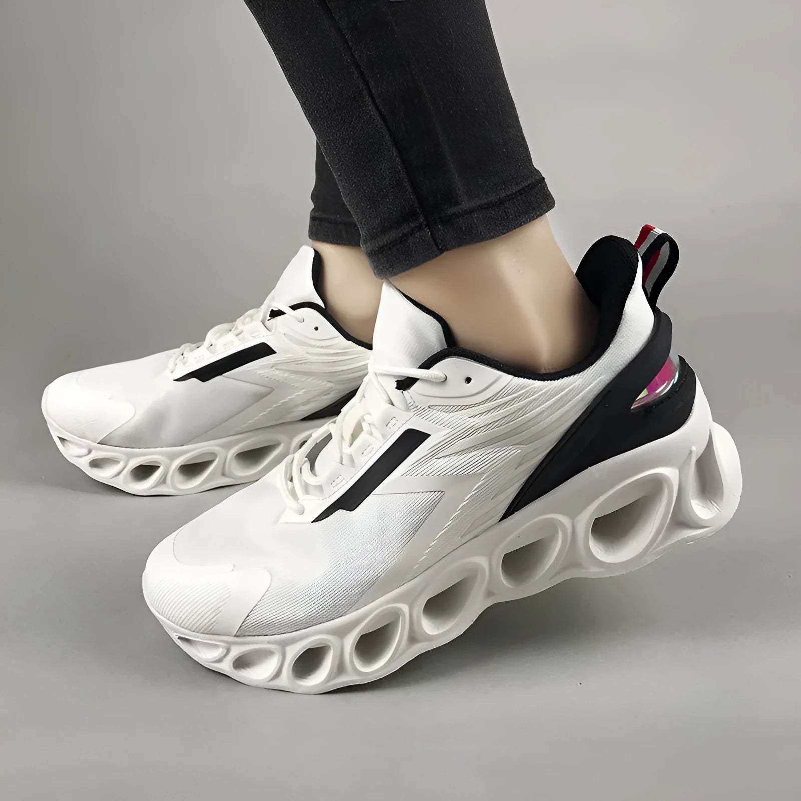 Breathable mesh men's casual sports shoes in black with white laces and a low-top EVA sole design.