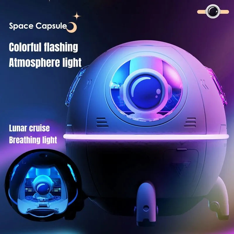 Purple astronaut space capsule USB humidifier with colourful LED lights on desktop