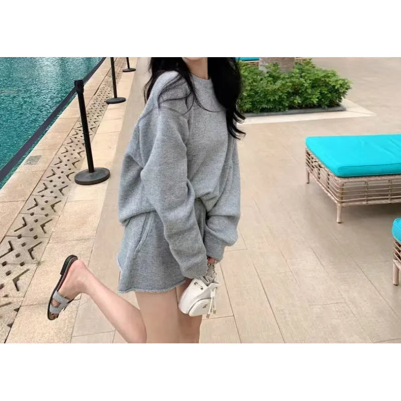 Women's knitted loose-fitting sweater and wide-leg shorts two-piece set in a neutral colour.