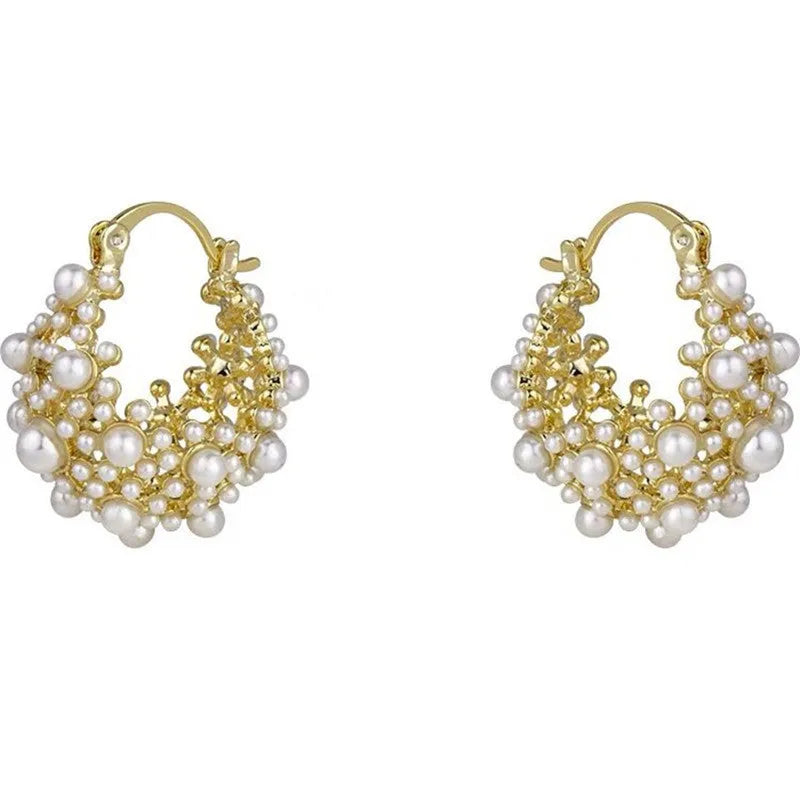 Gold-coloured copper flower basket earrings with small rice-shaped beads and pearl inlay detailing.