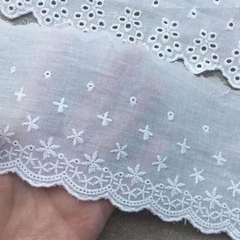 Cotton embroidered lace cutout trim roll showing four different width options for DIY clothing projects