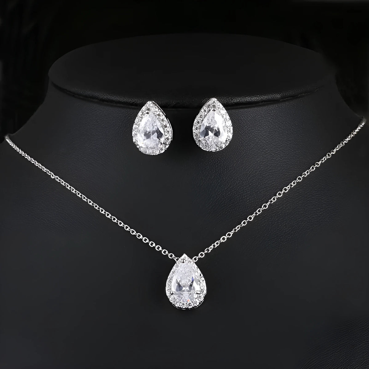 Women's water drop gemstone necklace and earrings set in copper with zircon on white background
