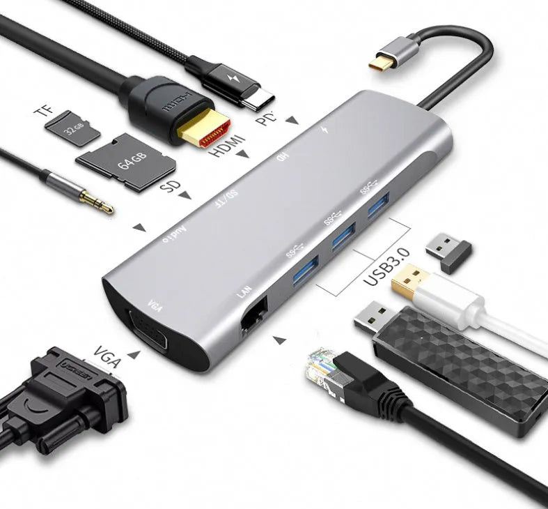 Grey aluminium USB-C docking station with HDMI, VGA, and USB ports on a desk.