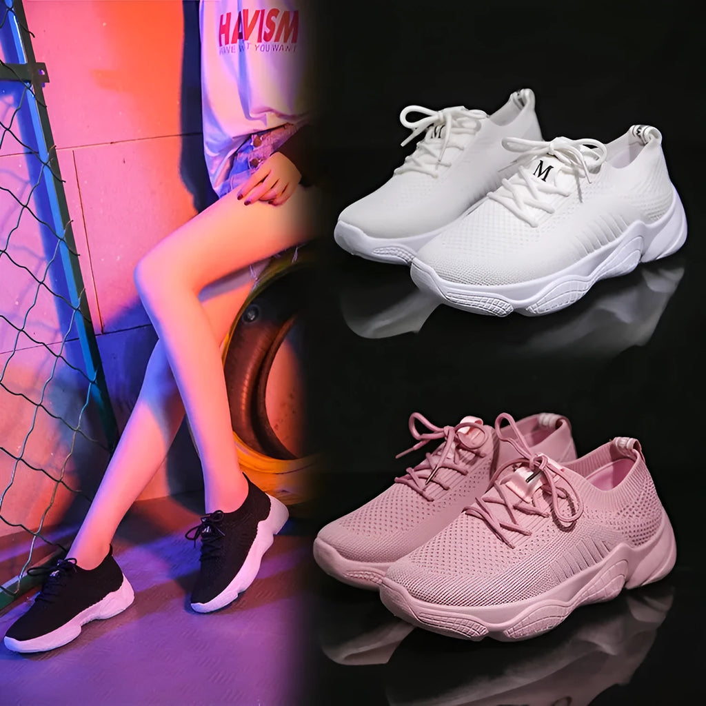 White thick-soled women's flyknit trainers with front strap and rubber sole.