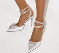Women's pink satin sandals with heart rhinestone, pointed toe, and cross strap on a 9.5cm heel.
