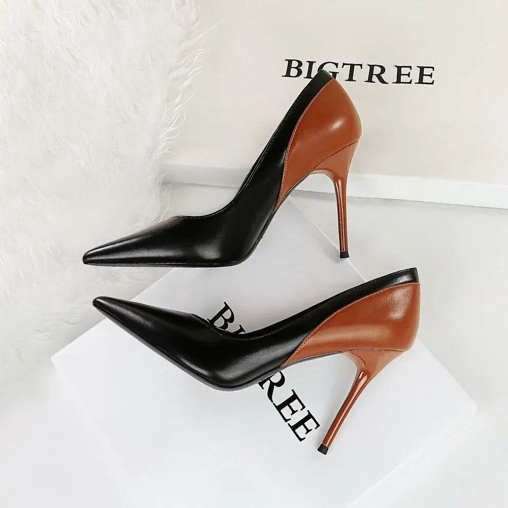 Retro black and creamy-white women's stiletto heels with pointed toe and high thin heel for banquet events.