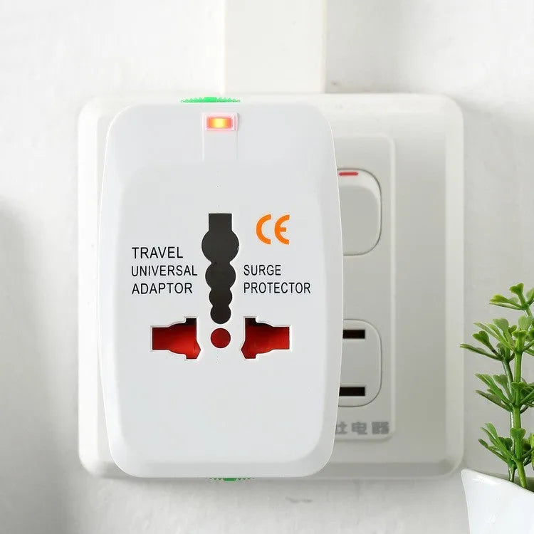 White universal travel plug adapter with dual USB ports and interchangeable UK EU US AU plugs on a plain background