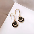 Black geometric alloy earrings with round pieces and 3.6cm length, retro Hong Kong style design.