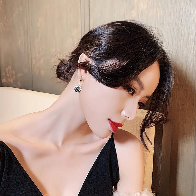 Black geometric alloy earrings with round pieces and 3.6cm length, retro Hong Kong style design.