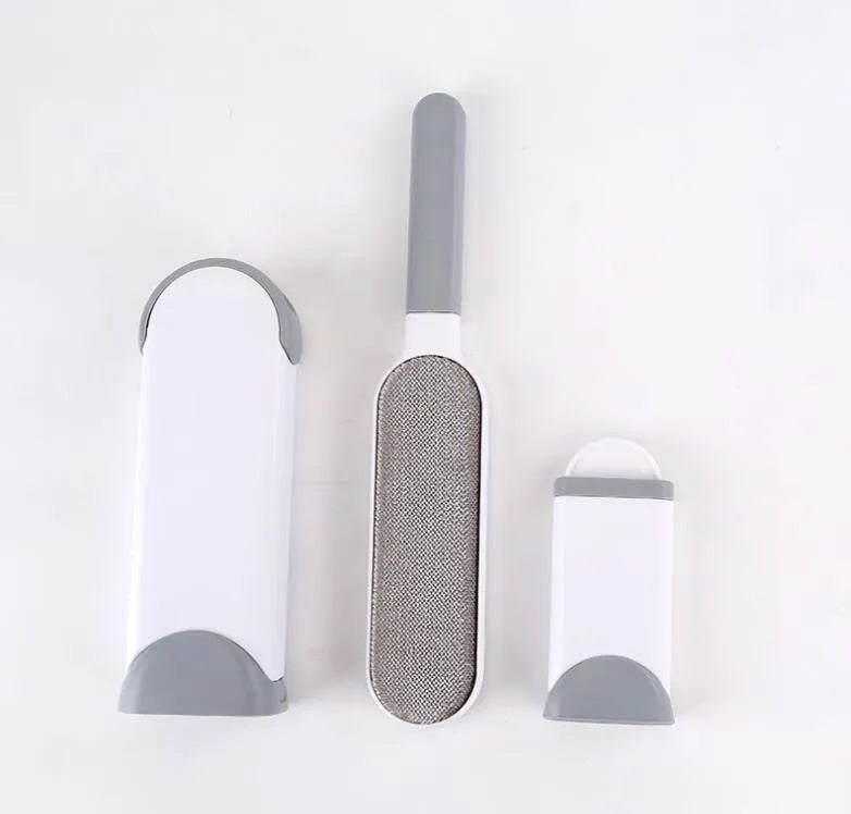 Blue reusable pet hair removal comb with double-sided sticky brush next to its self-cleaning base.