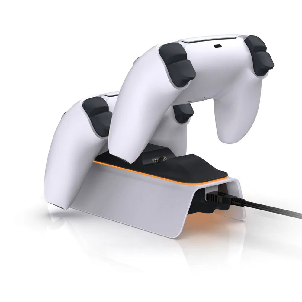 White PS5 dual controller charger with LED indicators and two gamepads docked on a wooden desk
