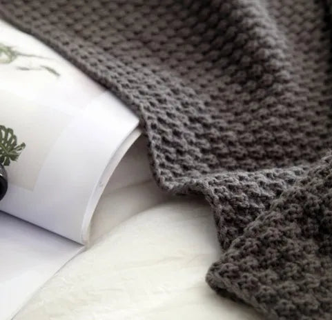 Nordic style fringed knit blanket in acrylic fabric, shown in beige colour, measuring 130 by 170 centimetres.