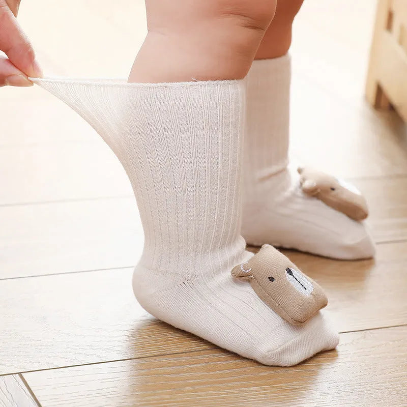 Baby socks with anti-slip dispensing glue in combed cotton, shown in multiple colours including blue bear print and pink cat.