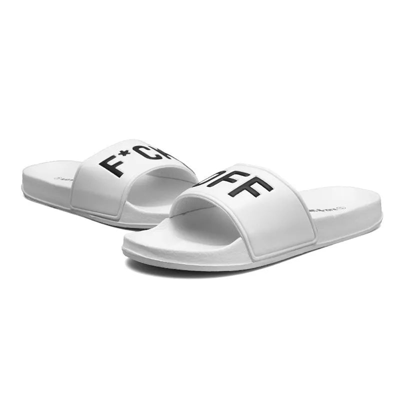 Men's large black and white open toe slippers with a rubber sole on a plain background.