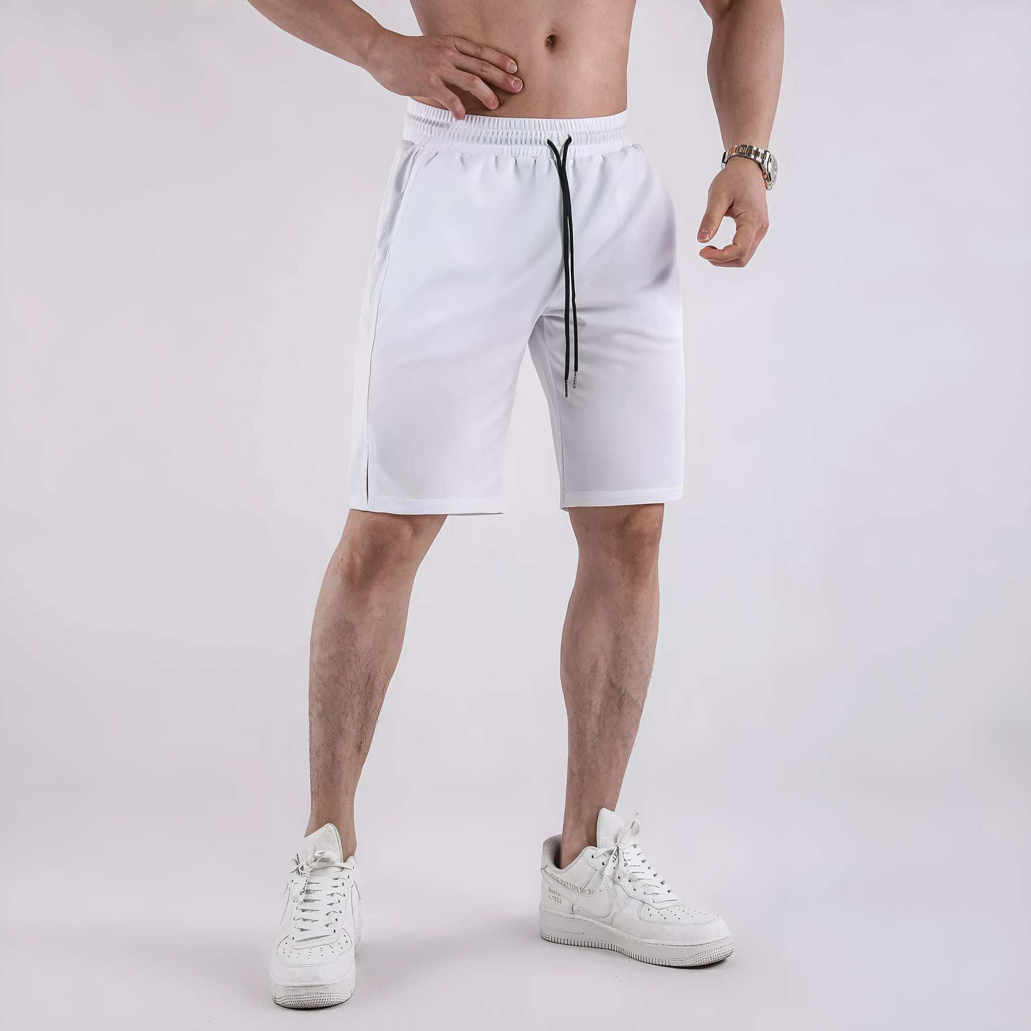 Men's black quick-dry mesh sports shorts with an elastic waistband on a white background.