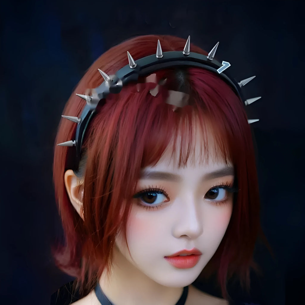 Punk rivet headband in black metal with tapered pointed nail spikes, unisex hair accessory on a solid background