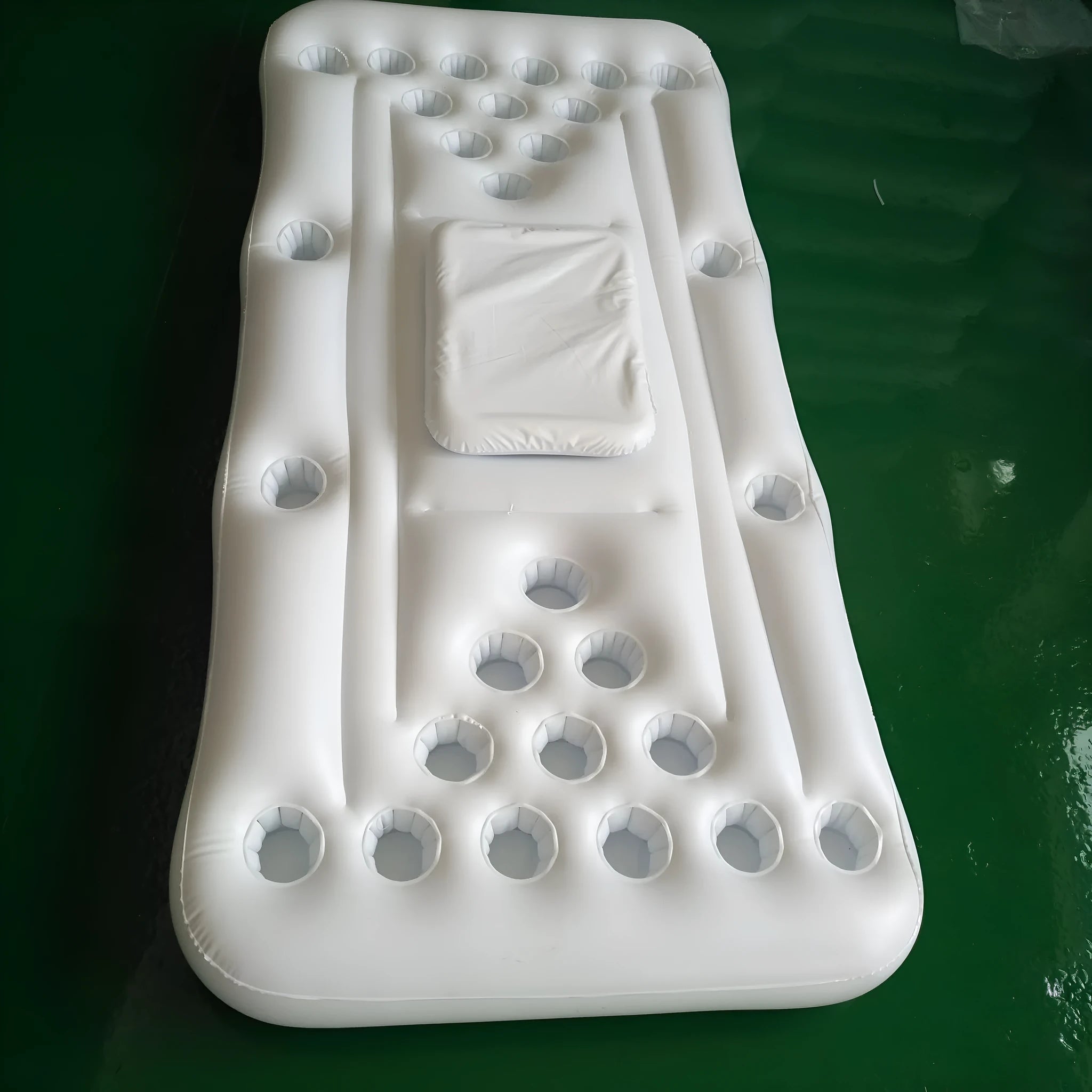 Inflatable beer pong buoy floating on pool water with cups set up on 24-hole blue surface