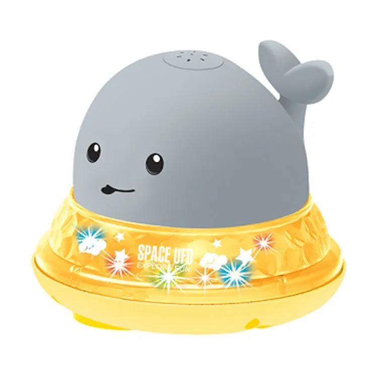 Grey and white whale bath toy with water spray, LED lights, floating in water