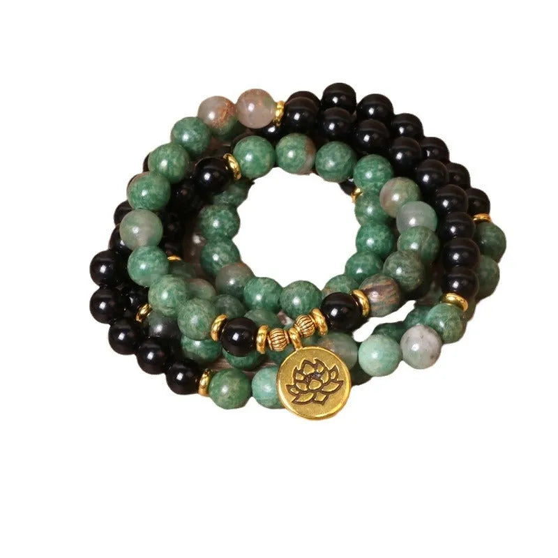 Green and black elastic beaded bracelet with alloy construction