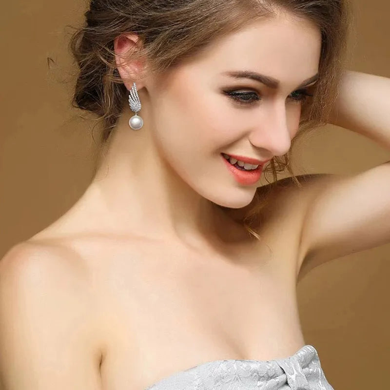 Silver angel wing earrings with diamond treatment and gold-plated gemstone accents