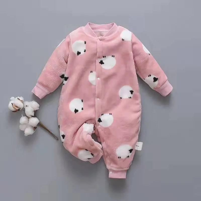 Baby wearing a long-sleeved flannel romper in a pink bunny head print, showcasing the 100% cotton fabric.