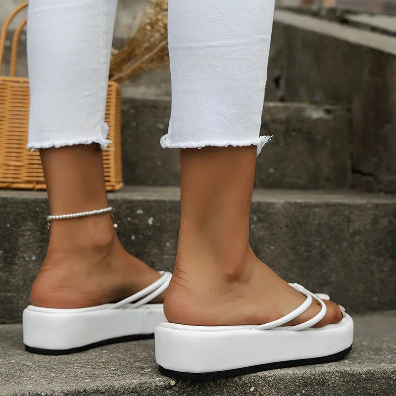 Casual thick-soled flip-flops in various colours on a white background.