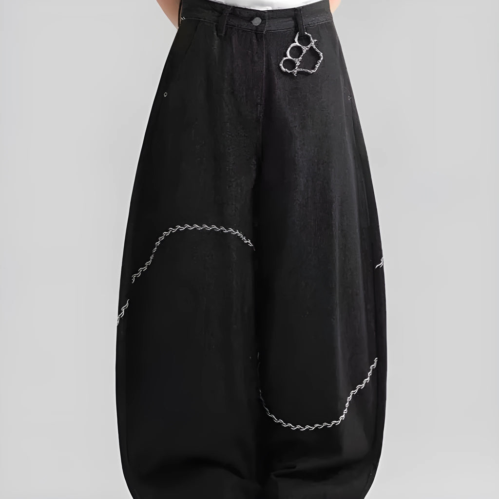 Black straight-leg denim trousers laid flat, showing zip fly and mid-waist design.