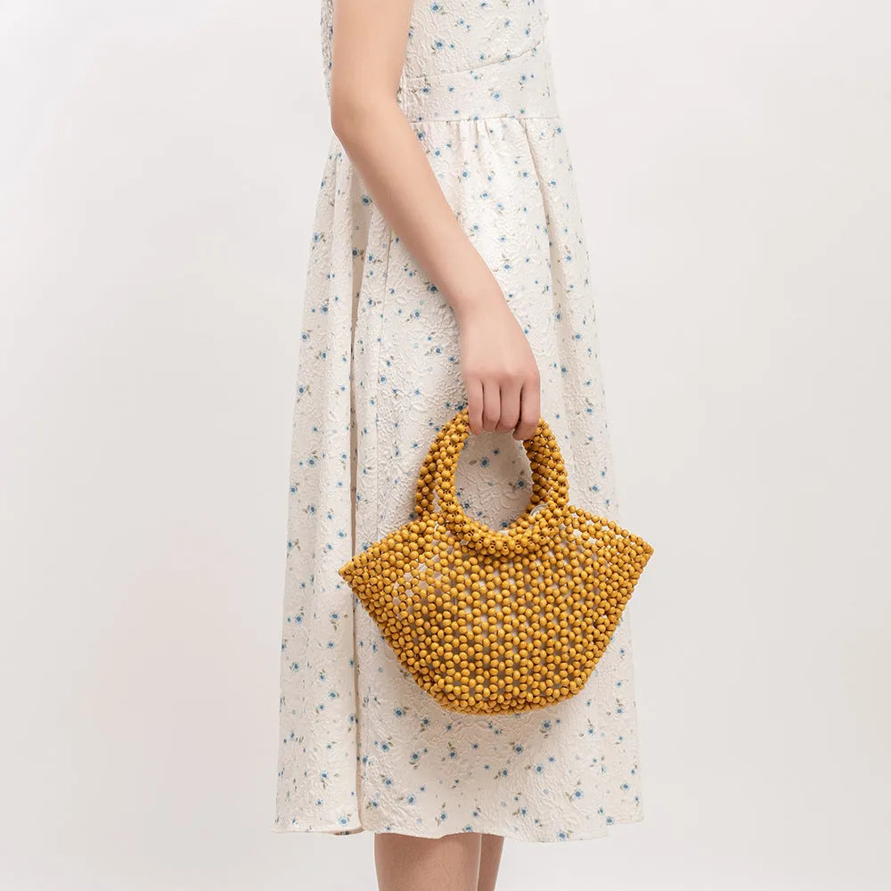 Hand-woven maple wooden bead beach bag in dumpling shape with hollow weave design