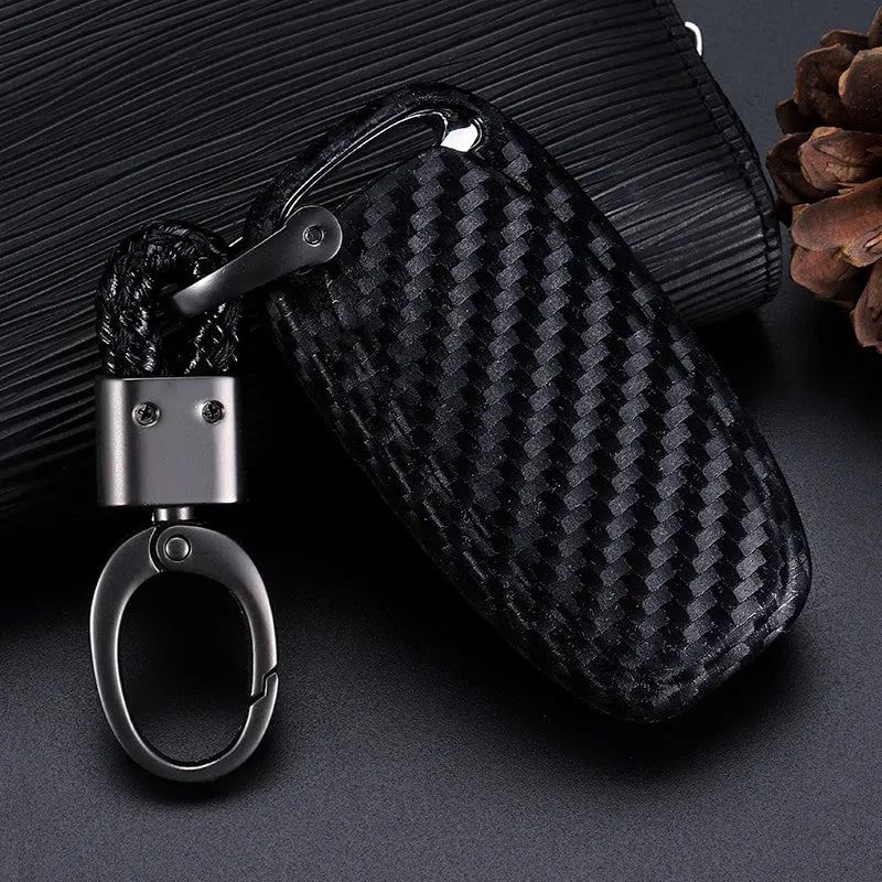 Carbon fibre silicone car key case in round button, single key or square key style, shown as a protective cover for car keys