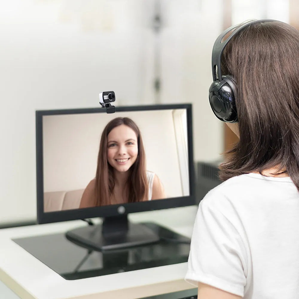 Blue mini USB webcam on a stand showing its 360-degree rotating base and focus ring.