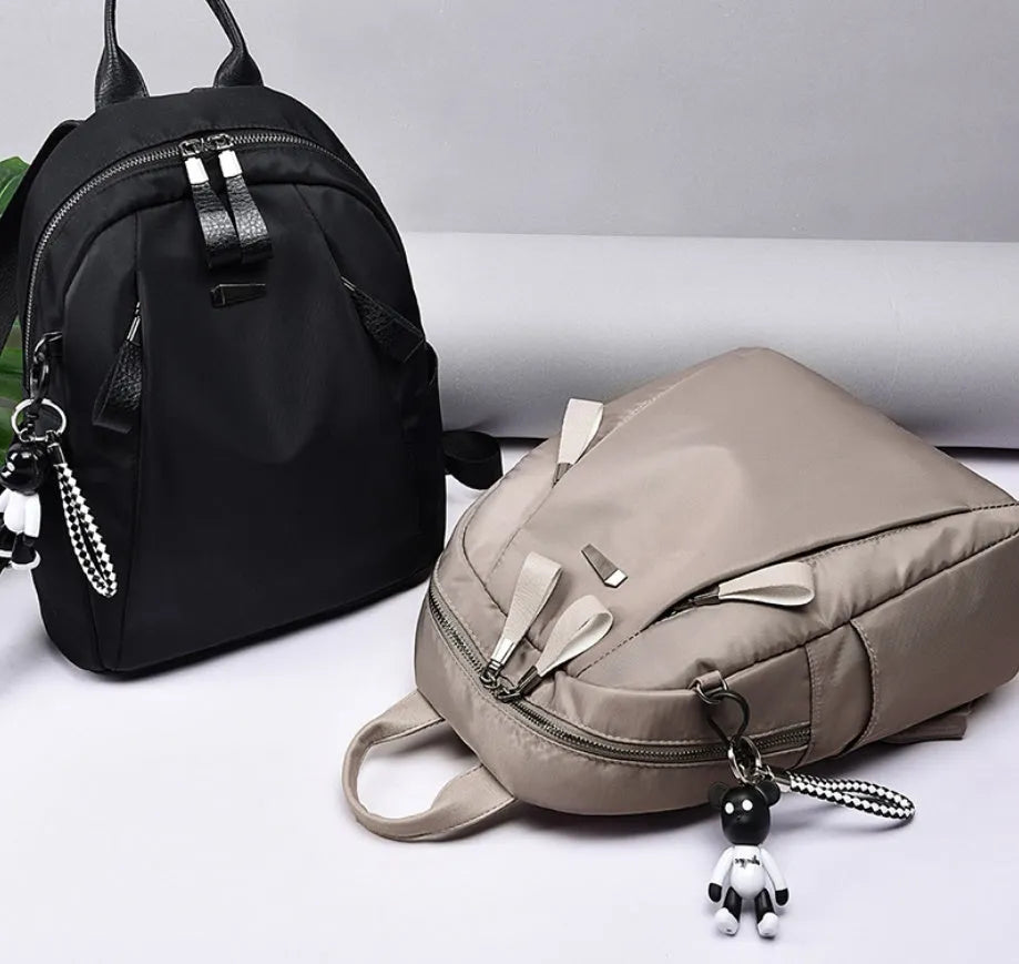 Medium square Oxford cloth rucksack in wine red with double straps and a front patch pocket.