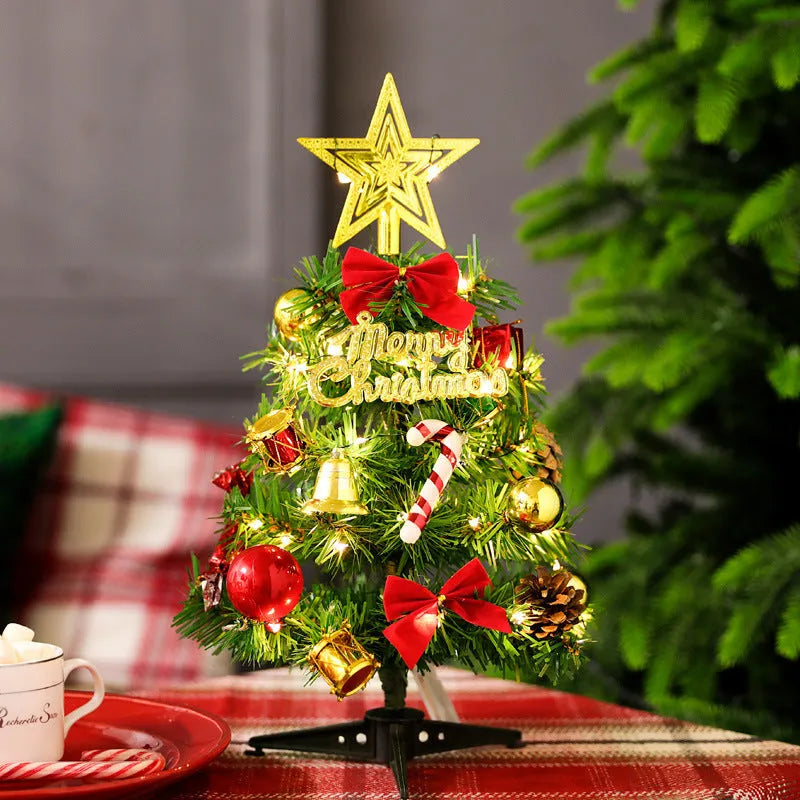 Mini Christmas tree 30cm tall in PVC, colour A, on a tabletop with festive background