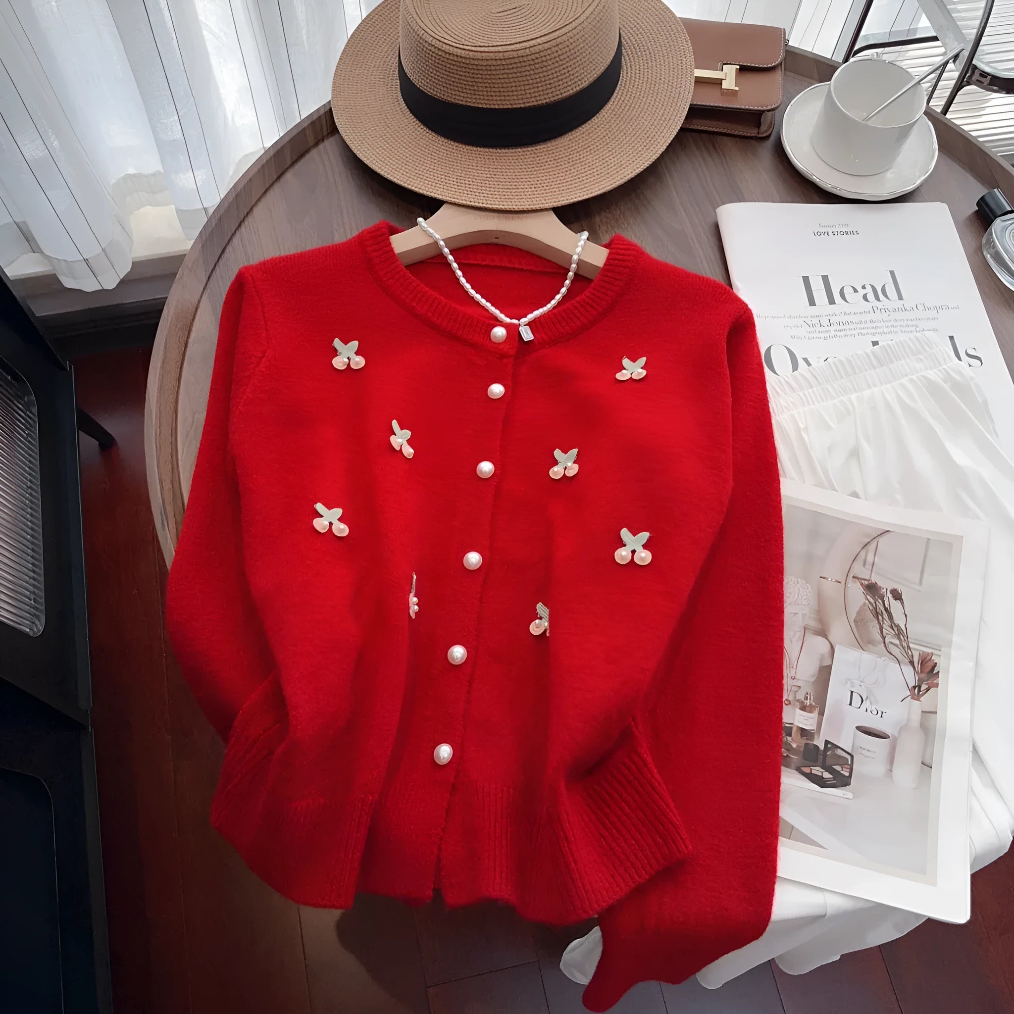 Pink cashmere blend cardigan with beaded detailing on the front, shown with a round neck and slim fit.